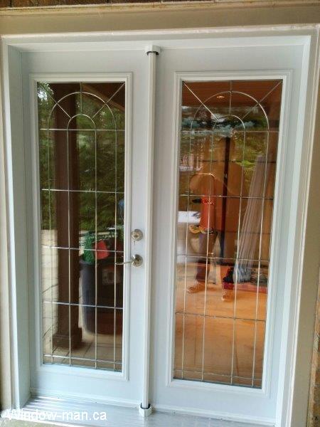 French door.  Patio door installation. Inswing full glass. White. Stained beveled Glass